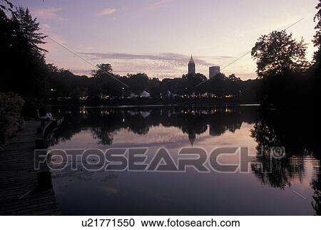 Stock Image -  Atlanta, skyline, GA, Georgia, Skyline of Midtown Atlanta reflecting in the pool at Piedmont Park in the evening.. Fotosearch