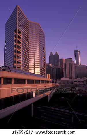 Stock Photo -  Atlanta, skyline, GA, Georgia, Skyline of downtown Atlanta. Downtown Connector I-75/85 passes under the MARTA station at sunset.. Fotosearch