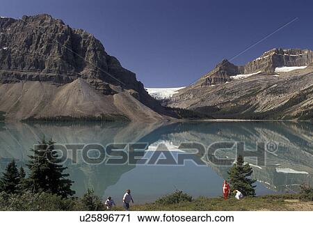 Banff National Park, Canada, Alberta, Canadian Rockies, Reflection of the surrounding mountains in the calm waters of Bow Lake in Banff National Park in Alberta. View Large Photo Image Stock Image - Banff National Park, Canada, Alberta, Canadian Rockies, Reflection of the surrounding mountains in the calm waters of Bow Lake in Banff National Park in Alberta.. Fotosearch