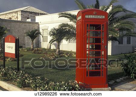 Stock Photograph -  Bermuda, Red telephone booth, The West End, Sandy's Parish, Red telephone booth outside The Cooperage at the Royal Naval Dockyard at the end of Ireland Island in Sandy's Parish in Bermuda. . Fotosearch