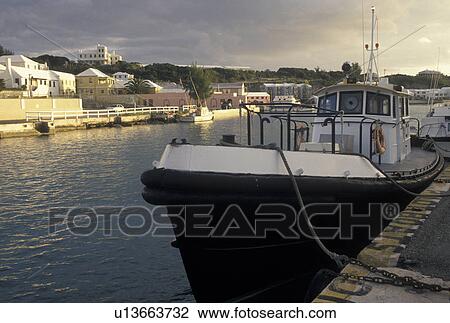 Stock Image -  Bermuda, St. George's Parish, Boats docked in St. George's Harbor in St George in Bermuda., . Fotosearch