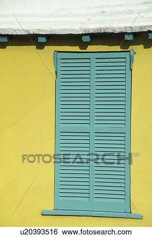 Stock Photograph -  Bermuda, St. George's Parish, Green shutters, yellow wall. Fotosearch