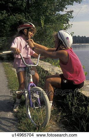 biking, helmet, safety, Stone Mountain, GA, Atlanta, Georgia, Mother helping eight year old daughter to put her helmet on at Georgia's Stone Mountain Park in Stone Mountain. View Large Photo Image Picture - biking, helmet, safety, Stone Mountain, GA, Atlanta, Georgia, Mother helping eight year old daughter to put her helmet on at Georgia's Stone Mountain Park in Stone Mountain. . Fotosearch