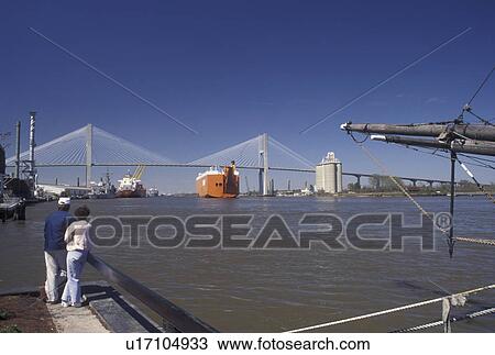 bridge, Savannah, GA, Georgia, A couple watches a freighter cruising under the Talmadge Memorial Bridge which crosses the Savannah River in Savannah. View Large Photo Image Stock Image - bridge, Savannah, GA, Georgia, A couple watches a freighter cruising under the Talmadge Memorial Bridge which crosses the Savannah River in Savannah.. Fotosearch