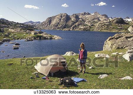 Stock Image -  camping, woman hiker, Wind River Range, hiking, Bridger-Teton National Forest, WY, Wyoming, Woman back country camping at Island Lake in the Wind River Range Mountains in the Bridger-Teton Nat'l Forest in Wyoming.. Fotosearch