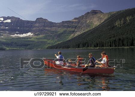 canoeing, Canada, Alberta, Waterton Lakes National Park, Canadian Rockies, A group of boys and their sister paddle a red canoe on Cameron Lake in Waterton-Glacier International Peace Park in Alberta. View Large Photo Image Stock Image - canoeing, Canada, Alberta, Waterton Lakes National Park, Canadian Rockies, A group of boys and their sister paddle a red canoe on Cameron Lake in Waterton-Glacier International Peace Park in Alberta.. Fotosearch