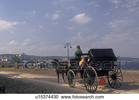 Stock Image -  carriage ride, Duluth, MN, Minnesota, Lake Superior, Carriage ride along Downtown Lakewalk along Lake Superior in Duluth. . Fotosearch