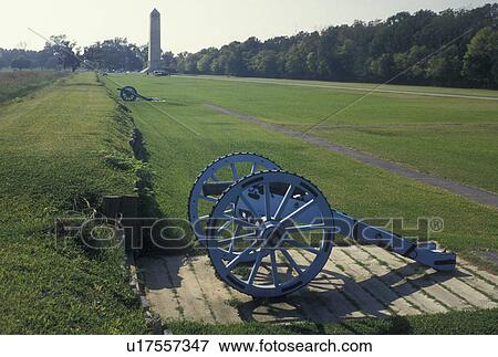 Stock Photo -  Chalmette Battlefield, cannon, LA, Jean Lafitte National Historical Park, New Orleans, Louisiana, Cannons at Battery 6 and Chalmette Monument on the grounds of the Chalmette Battlefield and National Cemetery at Jean Lafitte Nat'l Historical Park and Pres. Fotosearch