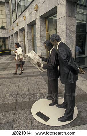 Stock Image -  Charlotte, NC, North Carolina, Second Hand News Statue in downtown Charlotte.. Fotosearch