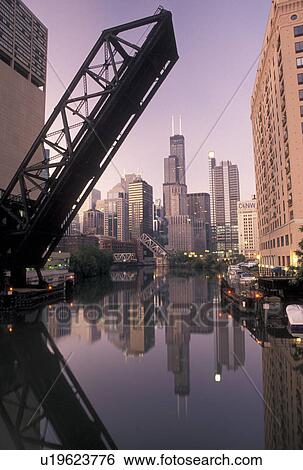 Chicago, drawbridge, skyline, IL, Illinois, Chicago River, A drawbridge in the up position shows the skyline of downtown Chicago reflecting in the Chicago River at sunrise. View Large Photo Image Stock Photograph - Chicago, drawbridge, skyline, IL, Illinois, Chicago River, A drawbridge in the up position shows the skyline of downtown Chicago reflecting in the Chicago River at sunrise.. Fotosearch