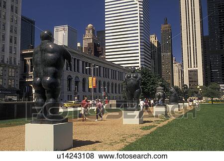 Stock Photo -  Chicago, IL, skyline, Illinois, Sculptures line the footpath in Grant Park. View of the skyline of downtown Chicago.. Fotosearch