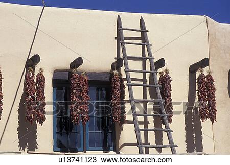 chili peppers, Taos, NM, New Mexico, Clusters of chili peppers hanging to dry outside an adobe style building in the village of Taos. View Large Photo Image Stock Image - chili peppers, Taos, NM, New Mexico, Clusters of chili peppers hanging to dry outside an adobe style building in the village of Taos.. Fotosearch