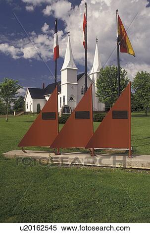 Stock Photography -  church, Shemogue, New Brunswick, NB, Canada, Boat sculpture with flags outside the church in the town of Shemogue in New Brunswick.. Fotosearch