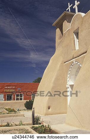 Stock Photograph -  church, Taos, mission, NM, New Mexico, San Francisco De Asis a mission church that exemplifies Franciscan Old World architecture in Taos.. Fotosearch