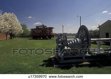 Stock Image -  city park, Selma, Alabama, AL, Little Red Caboose and Lathe displayed in Lafayette Park in Selma in the spring.. Fotosearch