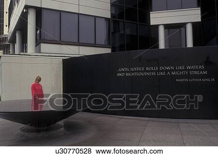 Civil Rights Memorial, Montgomery, AL, Alabama, A woman looks at the inscriptions written in the Civil Rights Memorial which stands in front of the Southern Poverty Law Center in Montgomery. View Large Photo Image Stock Photo - Civil Rights Memorial, Montgomery, AL, Alabama, A woman looks at the inscriptions written in the Civil Rights Memorial which stands in front of the Southern Poverty Law Center in Montgomery.. Fotosearch