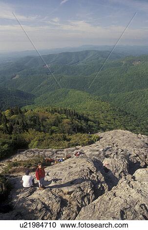 Stock Image -  climbing, hiking, mountains NC, Blue Ridge Parkway, North Carolina, Climbers resting at Devil's Courthouse along the Blue Ridge Parkway in North Carolina.. Fotosearch