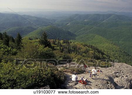 Stock Photo -  climbing, hiking, mountains NC, Blue Ridge Parkway, North Carolina, Climbers resting at Devil's Courthouse along the Blue Ridge Parkway in North Carolina.. Fotosearch