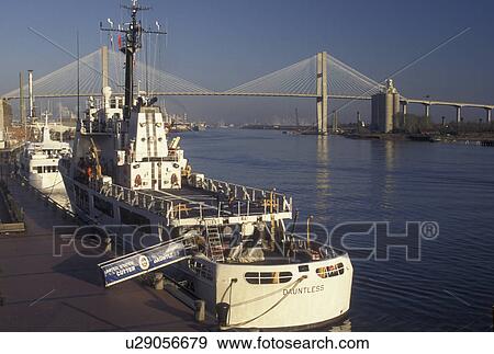 Stock Photo -  Coast Guard, Savannah, GA, Georgia, The Duntless, U. S. Coast Guard Boat, docked along the Historic River Front along the Savannah River in Savannah. Talmadge Memorial Bridge crossing the Savannah River in the distance.. Fotosearch