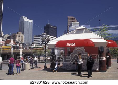 Stock Photo -  Coca-Cola, Atlanta, GA, Georgia, Coca-Cola Fountain outside Underground Atlanta at World of Coca-Cola and skyline of downtown Atlanta.. Fotosearch