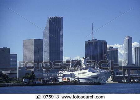 Stock Image -  cruise ship, Miami, FL, Florida, Atlantic Ocean, Cruise ship docked at the Port of Miami Biscayne Bay with a view of the downtown skyline of Miami.. Fotosearch