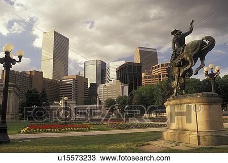 Denver, CO, Colorado, Statue of cowboy riding a bucking bronco in Civic Center Park and skyline of downtown Denver. View Large Photo Image Stock Image - Denver, CO, Colorado, Statue of cowboy riding a bucking bronco in Civic Center Park and skyline of downtown Denver.. Fotosearch