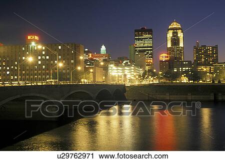 Stock Image -  Des Moines, IA, Iowa, The downtown skyline of Des Moines reflects in the Des Moines River in the evening.. Fotosearch