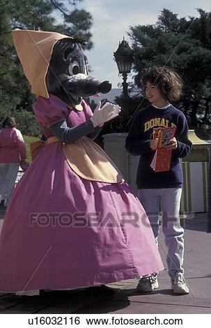 Stock Photograph -  Disney World, FL, Orlando, Magic Kingdom, Lake Buena Vista, Florida, Cinderella's Mouse signs an autograph for a young girl in the Magic Kingdom at Walt Disney World in Lake Buena Vista.. Fotosearch