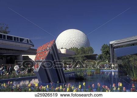 Stock Photo -  Disney World, FL, Orlando, monorail, Epcot, Lake Buena Vista, Florida, Monorail passes by the fountain outside the Universe of Energy presented by Exxon and Spaceship Earth in Epcot Center at Walt Disney World in Lake Buena Vista. . Fotosearch