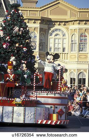 Picture -  Disney World, Orlando, FL, Magic Kingdom, Lake Buena Vista, Florida, Mickey Mouse and Minnie Mouse wave from a float at A Very Merry Christmas Parade during the Christmas holiday on Main Street U. S. A. in the Magic Kingdom at Walt Disney World in Lake Bue. Fotosearch