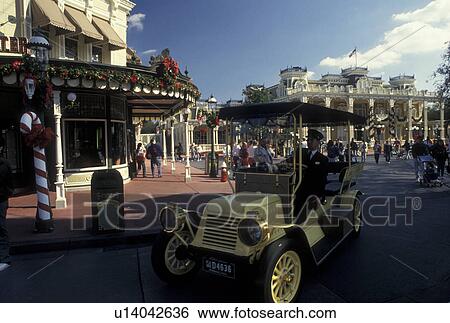 Disney World, Orlando, Lake Buena Vista, FL, Florida, Magic Kingdom, Replica on an antique taxi rides down Main Street U. S. A. during the Christmas holiday in the Magic Kingdom at Walt Disney World in Lake Buena Vista. View Large Photo Image Stock Photograph - Disney World, Orlando, Lake Buena Vista, FL, Florida, Magic Kingdom, Replica on an antique taxi rides down Main Street U. S. A. during the Christmas holiday in the Magic Kingdom at Walt Disney World in Lake Buena Vista.. Fotosearch