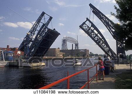 drawbridge, Duluth, MN, Minnesota, Lake Superior, Minnesota Slip Bridge, a pedestrian drawbridge, in the up position for a boat to cruise through on Duluth Harbor in Duluth. View Large Photo Image Stock Photo - drawbridge, Duluth, MN, Minnesota, Lake Superior, Minnesota Slip Bridge, a pedestrian drawbridge, in the up position for a boat to cruise through on Duluth Harbor in Duluth.. Fotosearch