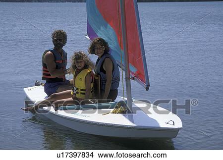 family, sailing, MN, Minnesota, Alexandria, Father takes his two daughters, ages 8 and 13 years old, sailing on a sunfish on Maple Lake in Alexandria in the summer. View Large Photo Image Picture - family, sailing, MN, Minnesota, Alexandria, Father takes his two daughters, ages 8 and 13 years old, sailing on a sunfish on Maple Lake in Alexandria in the summer.. Fotosearch