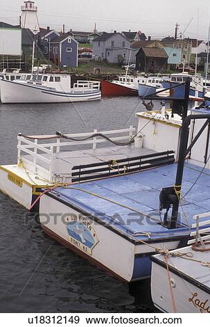 Stock Photo -  fishing boat, Cape Breton, Cabot Trail, Nova Scotia, NS, Canada, Fishing boats moored in the harbor in the fishing village of Cheticamp on Cape Breton Island on in Nova Scotia. . Fotosearch