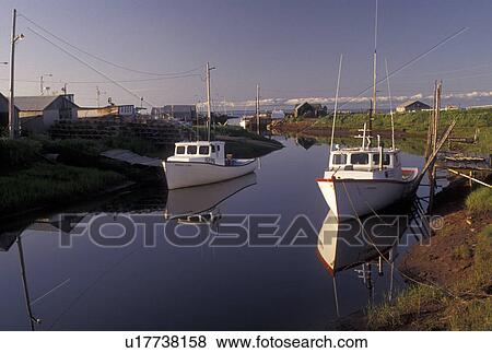 Stock Photo -  fishing boat, Nova Scotia, Toney River, NS, Canada, Gulf of St. Lawrence, Lobster fishing boats reflect in the calm water of Toney River in Nova Scotia. . Fotosearch