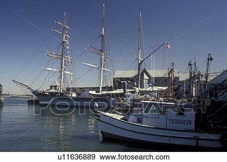 Stock Photo -  fishing boats, The Elissa, Galveston, TX, Texas, Gulf of Mexico, Shrimp boats and The Elissa, a 1877 restored three-masted barque, at Pier 21 on the Gulf Coast in Galveston.. Fotosearch