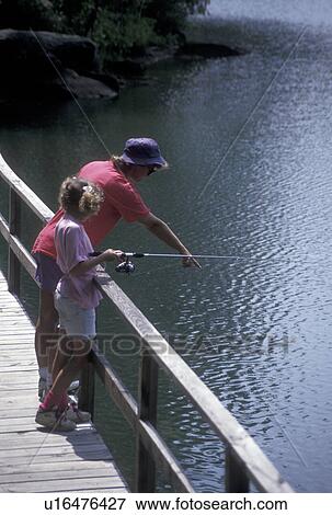 fishing, Chattahoochee National Forest, GA, Georgia, Mother points at fish in water while nine year old daughter fishes off a dock on Lake Tallulah in the Chattahoochee National Forest in North Georgia. View Large Photo Image Stock Photo - fishing, Chattahoochee National Forest, GA, Georgia, Mother points at fish in water while nine year old daughter fishes off a dock on Lake Tallulah in the Chattahoochee National Forest in North Georgia.. Fotosearch