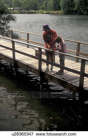Stock Photo -  fishing, Chattahoochee National Forest, GA, Georgia, Mother and nine year old daughter fishing off a dock on Lake Tallulah in the Chattahoochee National Forest in North Georgia.. Fotosearch