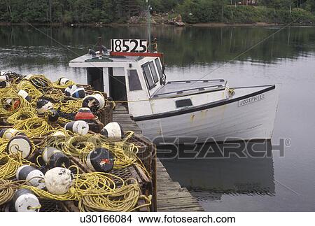 fishing nets, fishing boat, Cape Breton, Cabot Trail, Nova Scotia, NS, Canada, Fishing boat and fishing nets on a dock on Cape Breton Island on in Nova Scotia. View Large Photo Image Picture - fishing nets, fishing boat, Cape Breton, Cabot Trail, Nova Scotia, NS, Canada, Fishing boat and fishing nets on a dock on Cape Breton Island on in Nova Scotia. . Fotosearch
