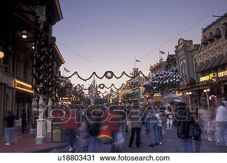 FL, Disney World, Florida, Orlando, Magic Kingdom, Lake Buena Vista, A crowd of people walk down Main Street U. S. A. in the evening during the Christmas holidays in the Magic Kingdom at Walt Disney World in Lake Buena Vista. View Large Photo Image Stock Image - FL, Disney World, Florida, Orlando, Magic Kingdom, Lake Buena Vista, A crowd of people walk down Main Street U. S. A. in the evening during the Christmas holidays in the Magic Kingdom at Walt Disney World in Lake Buena Vista.. Fotosearch