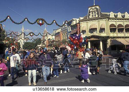 FL, Disney World, Orlando, Lake Buena Vista, Florida, A crowd of people walk down Main Street U. S. A. during the Christmas holiday in the Magic Kingdom at Walt Disney World in Lake Buena Vista. View Large Photo Image Stock Photo - FL, Disney World, Orlando, Lake Buena Vista, Florida, A crowd of people walk down Main Street U. S. A. during the Christmas holiday in the Magic Kingdom at Walt Disney World in Lake Buena Vista.. Fotosearch