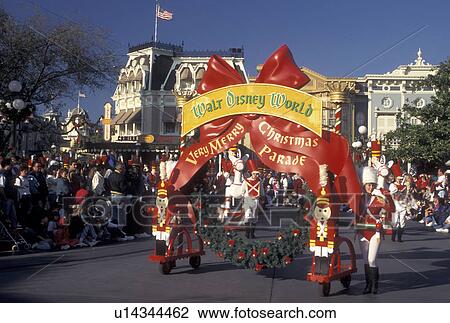 Stock Image -  FL, parade, Florida, Disney World, Orlando, Magic Kingdom, Lake Buena Vista, Crowds line Main Street U. S. A. for A Very Merry Christmas Parade during the Christmas holiday in the Magic Kingdom at Walt Disney World in Lake Buena Vista.. Fotosearch