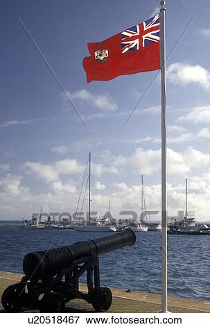 flag, cannon, Bermuda, The West End, Sandy's Parish, The Bermuda flag fly's over the waterfront at the Royal Naval Dockyard at the end of Ireland Island in Sandy's Parish in Bermuda. View Large Photo Image Stock Photo - flag, cannon, Bermuda, The West End, Sandy's Parish, The Bermuda flag fly's over the waterfront at the Royal Naval Dockyard at the end of Ireland Island in Sandy's Parish in Bermuda. . Fotosearch