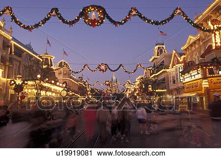 Florida, FL, Disney World, Orlando, Magic Kingdom, Lake Buena Vista, A crowd of people walk down Main Street U. S. A. in the evening during the Christmas holidays in the Magic Kingdom at Walt Disney World in Lake Buena Vista. View Large Photo Image Stock Image - Florida, FL, Disney World, Orlando, Magic Kingdom, Lake Buena Vista, A crowd of people walk down Main Street U. S. A. in the evening during the Christmas holidays in the Magic Kingdom at Walt Disney World in Lake Buena Vista.. Fotosearch