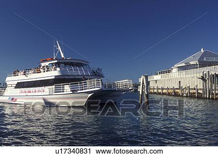Stock Image -  Florida Keys, Key West, FL, Gulf of Mexico, Florida, Atlantic Ocean, Glass bottom sightseeing boat pulls into Sunset Deck on the Gulf of Mexico in Key West.. Fotosearch