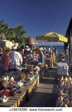 Stock Image -  Florida Keys, Key West, FL, Gulf of Mexico, Florida, Atlantic Ocean, Street vendors line the street at the Southernmost Point in the Continental United States in Key West.. Fotosearch