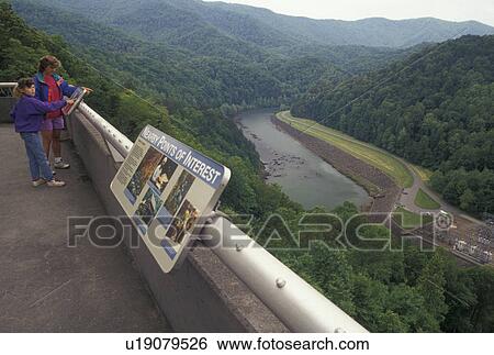 Stock Photograph -  Fontana Dam, NC, North Carolina, Mother and daughter at Fontana Dam overlook, the tallest dam in the Eastern United States, Tennessee Valley Authority.. Fotosearch