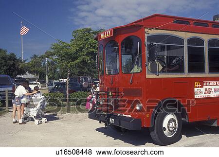 Fort Myers, FL, trolley, Gulf of Mexico, Florida, Red trolley bus picks up passengers along the beach front in Fort Myers. View Large Photo Image Stock Photo - Fort Myers, FL, trolley, Gulf of Mexico, Florida, Red trolley bus picks up passengers along the beach front in Fort Myers.. Fotosearch