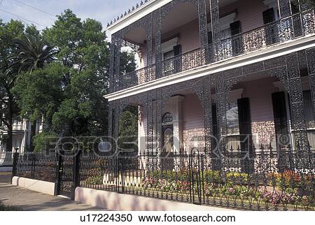 Stock Image -  Garden District, New Orleans, LA, mansion, Louisiana, Ornate mansion with cast iron railings in the Garden District in New Orleans. . Fotosearch