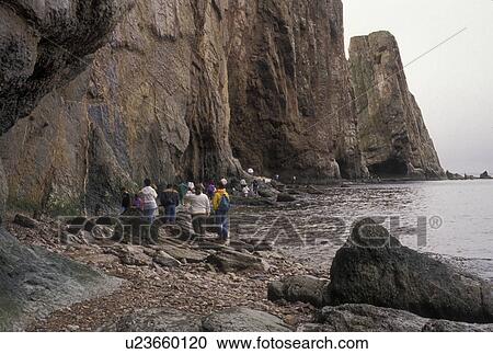 Gaspe Peninsula, Perce, Quebec, Canada, Perce Rock, Gulf of St. Lawrence, People walking along Rocher Perce (Perce Rock) at low tide on the Gulf of St. Lawrence in Perce on Gaspe Peninsula in Quebec. View Large Photo Image Stock Image - Gaspe Peninsula, Perce, Quebec, Canada, Perce Rock, Gulf of St. Lawrence, People walking along Rocher Perce (Perce Rock) at low tide on the Gulf of St. Lawrence in Perce on Gaspe Peninsula in Quebec.. Fotosearch